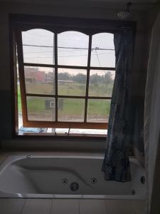 a bath tub in a bathroom with a window at La casona de ensueño in Formosa