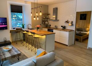 a kitchen and living room with a couch and a table at Apartment Chinook,La Praz,Chamonix Mont Blanc in Chamonix