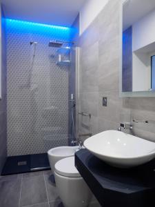 a bathroom with a sink and a toilet and a shower at Plebiscito Home Holidays in Naples