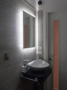 a bathroom with a sink and a mirror at Plebiscito Home Holidays in Naples +26 photos