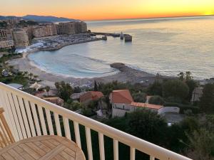 - un balcon offrant une vue sur la plage au coucher du soleil dans l'établissement wonderfull view cap d ail monaco, à Saint-Antoine