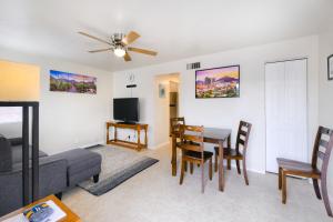 a living room with a couch and a dining room table at Orchard Bungalow in Tucson