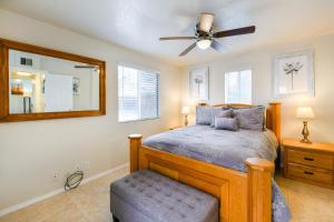 a bedroom with a bed and a ceiling fan at Orchard Bungalow in Tucson