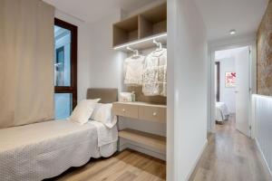 a small bedroom with a bed and a window at LucasLand Apartments Barcelona in Barcelona