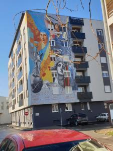 a building with a mural on the side of it at Dimitra apartman in Šabac