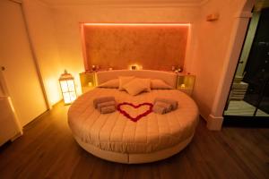 a bedroom with a bed with a heart on it at Wellness Home Crisalide SPA in Fasano