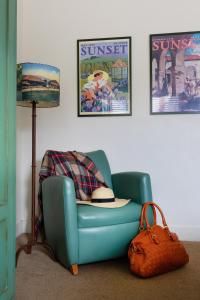 a living room with a blue chair and a lamp at Sonoma Creek Inn in Sonoma