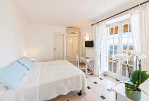 Postel nebo postele na pokoji v ubytování Paradise Relais Villa Janto'
