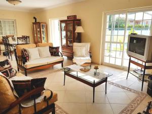 a living room with couches and a tv at B House Verdizela in Corroios