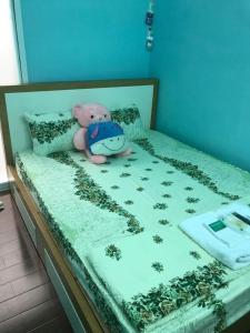 a teddy bear sitting on top of a bed at Saigonnais Homestay (Maison de Tran Le) in Ho Chi Minh City