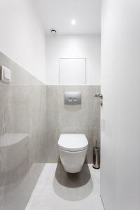 a bathroom with a white toilet and a bath tub at Luxury loft in paris in Paris