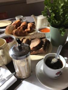 una mesa con un plato de pan y una taza de café en Les Terres Rouges 06, en Guillaumes