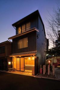 a black building with a lot of windows at Connect inn Shichijo-Kamogawa in Kyoto