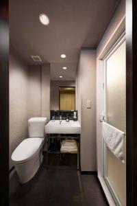 a bathroom with a toilet and a sink at Connect inn Shichijo-Kamogawa in Kyoto +25 photos