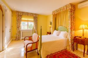 a bedroom with a bed and a chair and a window at Can Mandol Villa in Inca +32 photos