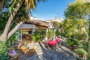 a house with a patio with tables and chairs at Can Mandol Villa in Inca
