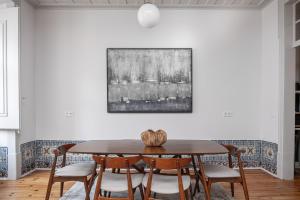 a dining room with a table and chairs at Nomad's Padaria Collection Lisbon in Lisbon