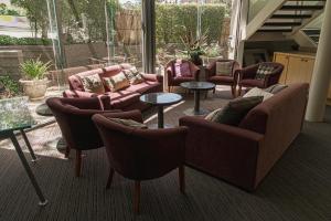 a living room with couches and tables and chairs at Melbourne Kew Central Apartments Official in Melbourne +16 photos