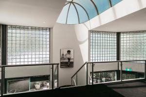 a room with two large windows and a large chandelier at Melbourne Kew Central Apartments Official in Melbourne