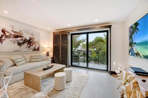 a living room with a couch and a table at Bali Hai Beach Resort in Holmes Beach