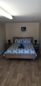 a bedroom with a bed with a wooden floor at Green Head Caravan Park in Green Head