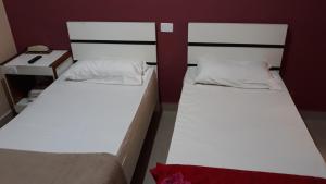 two bunk beds in a room with a desk and a bed at Top Mix Hotel in São Bernardo do Campo