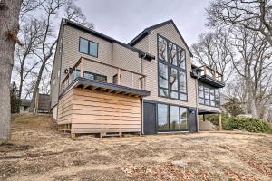 a large wooden house with a lot of windows at 1 Mi to Ferry and Beach Waterfront Hyannis Home! in Hyannis