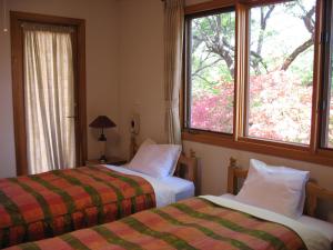 Postel nebo postele na pokoji v ubytování B&B 1組貸切のペンション Second House Plus