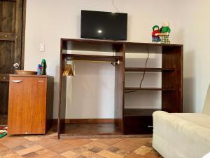 a living room with a tv on top of a table at La Casona Cucaita in Cucaita