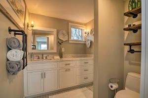 a bathroom with a sink and a mirror at 1 Mi to Ferry and Beach Waterfront Hyannis Home! in Hyannis