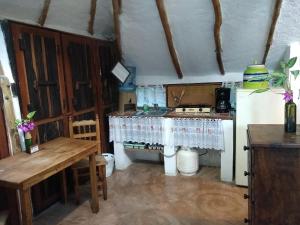 a kitchen with a stove and a table in it at Casitas Kinsol in Puerto Morelos