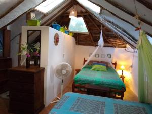 a bedroom with a bed in a attic at Casitas Kinsol in Puerto Morelos