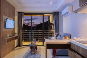 a hotel room with a view of a balcony at NaiHarn Sea Condo by Holy Cow, 1-BR, mountain view in Nai Harn Beach