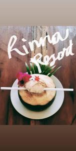 a cake on a plate with a flower on it at Rinna Resort in Koh Mook