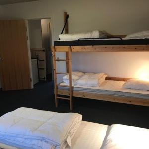 two bunk beds in a room with two mattresses at Sæby Spektrum & Hostel in Sæby