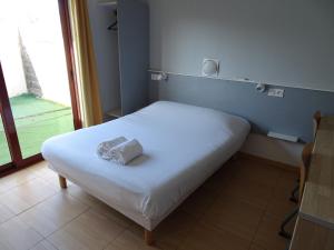 Postel nebo postele na pokoji v ubytování Hôtel Acajou
