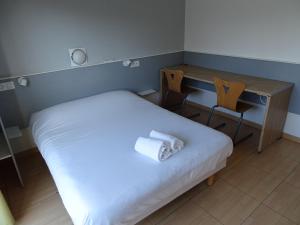 Postel nebo postele na pokoji v ubytování Hôtel Acajou