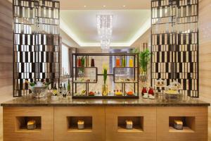 a buffet in a hotel lobby with a counter at Crowne Plaza Tianjin Meijiangnan, an IHG Hotel in Tianjin