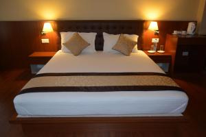 Juniper Residency Hotel tesisinde bir odada yatak veya yataklar