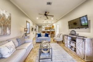 a living room with a couch and a tv at The Village at Gruene in New Braunfels