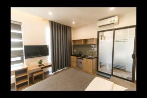 a large room with a kitchen with a large window at AHA Thang Bom Apartment Da Nang in Da Nang