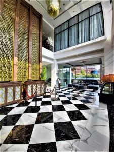 a lobby with a black and white checkered floor at Savero Style Bogor in Bogor
