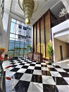 a lobby with a black and white checkered floor at Savero Style Bogor in Bogor