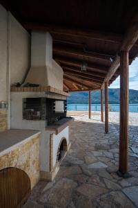 an outdoor oven with a beach in the background at Velanidia Apartments in Plataria