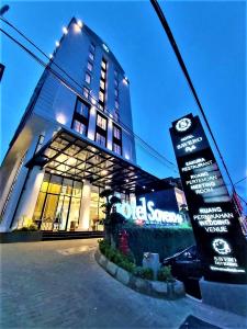a building with a sign in front of it at Savero Style Bogor in Bogor