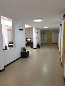 an empty hallway of an office with potted plants at Admiralmahé in Mahébourg