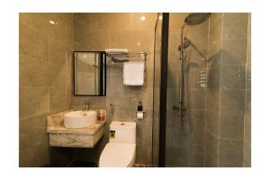 a bathroom with a toilet and a sink and a shower at AHA Thang Bom Apartment Da Nang in Danang +16 photos