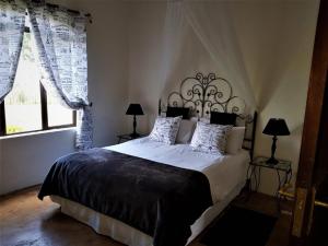 a bedroom with a large bed and a window at River Crossing in Champagne Valley