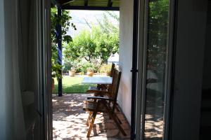 an open door to a patio with a table and chairs at Villa Rosanna in Plataria