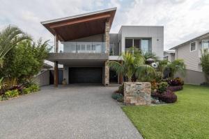 a large house with a large garage in a yard at East Woonona Sea Esta Studio in Woonona